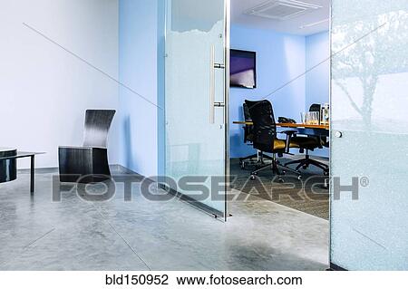 Glass doorway opening to desk in office View Large Photo Image Stock Image - Glass doorway opening to desk in office. Fotosearch