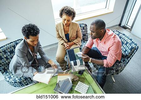 High angle view of business people examining swatches in office lobby View Large Photo Image Stock Photograph - High angle view of business people examining swatches in office lobby. Fotosearch