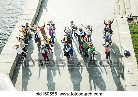 High angle view of Caucasian children waving from waterfront View Large Photo Image Stock Photography - High angle view of Caucasian children waving from waterfront. Fotosearch
