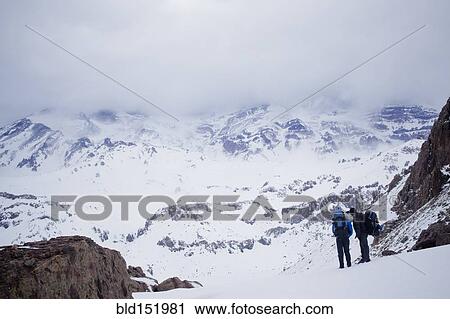 Hispanic hikers admiring snowy scenic mountains View Large Photo Image Stock Image - Hispanic hikers admiring snowy scenic mountains. Fotosearch