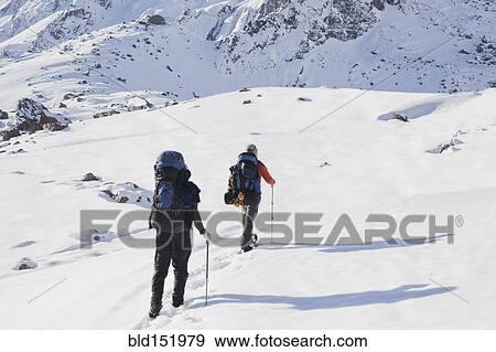 Hispanic hikers walking on snowy mountain View Large Photo Image Stock Photo - Hispanic hikers walking on snowy mountain. Fotosearch