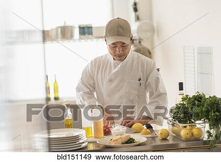 Stock Photo - Korean chef slicing food in kitchen. Fotosearch