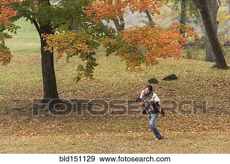 Man carrying girlfriend piggyback in park View Large Photo Image Stock Photo - Man carrying girlfriend piggyback in park. Fotosearch