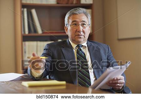 Mixed race businessman talking in office View Large Photo Image Picture - Mixed race businessman talking in office. Fotosearch