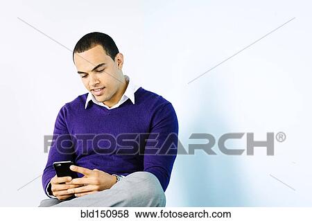 Mixed race businessman using cell phone View Large Photo Image Stock Photo - Mixed race businessman using cell phone. Fotosearch