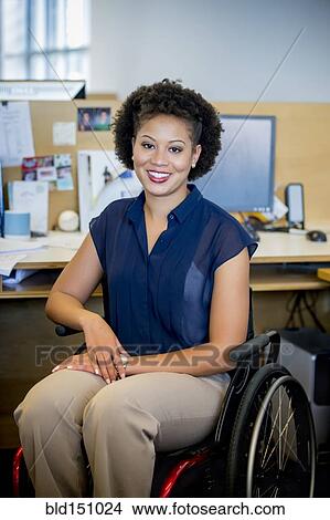 Mixed race businesswoman in wheelchair at office desk View Large Photo Image Picture - Mixed race businesswoman in wheelchair at office desk. Fotosearch