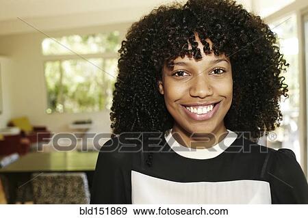 Mixed race businesswoman smiling in dining room View Large Photo Image Stock Photo - Mixed race businesswoman smiling in dining room. Fotosearch