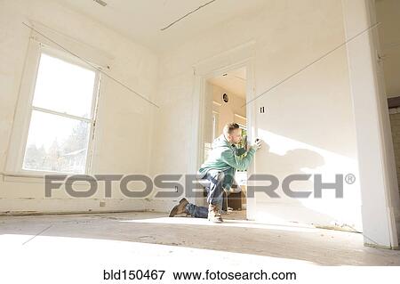 Mixed race carpenter working on doorway View Large Photo Image Stock Photo - Mixed race carpenter working on doorway. Fotosearch