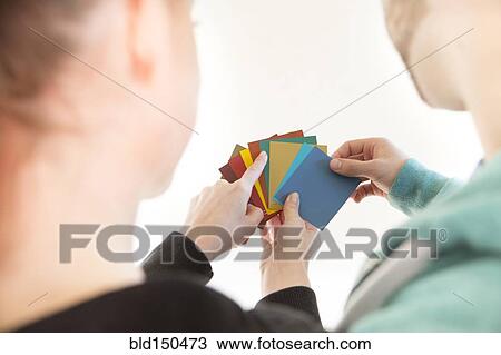 Mixed race couple selecting color swatches View Large Photo Image Stock Image - Mixed race couple selecting color swatches. Fotosearch