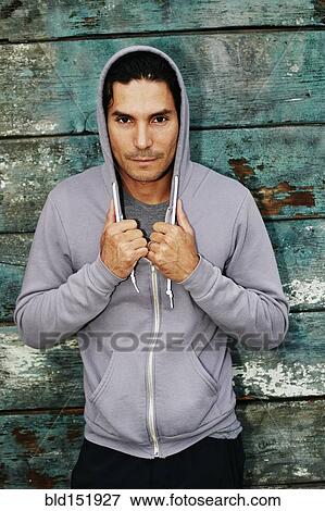 Stock Photo - Mixed race man wearing hoody. Fotosearch