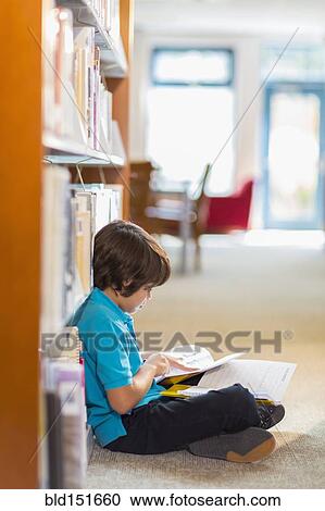 Mixed race student reading books on floor in library View Large Photo Image Stock Image - Mixed race student reading books on floor in library. Fotosearch