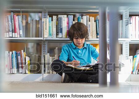 Mixed race student writing in notebook on floor in library View Large Photo Image Stock Image - Mixed race student writing in notebook on floor in library. Fotosearch