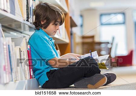Mixed race student writing in notepad on floor in library View Large Photo Image Stock Photo - Mixed race student writing in notepad on floor in library. Fotosearch