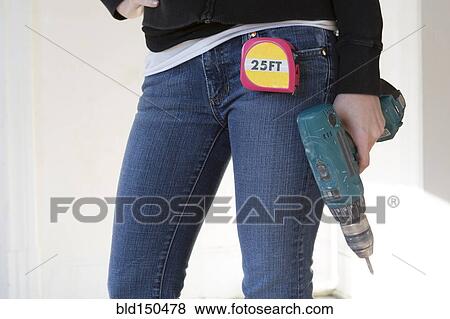 Mixed race woman holding power drill View Large Photo Image Stock Photo - Mixed race woman holding power drill. Fotosearch