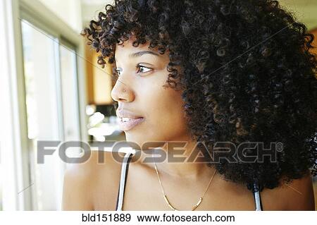 Mixed race woman looking out window View Large Photo Image Stock Photo - Mixed race woman looking out window. Fotosearch