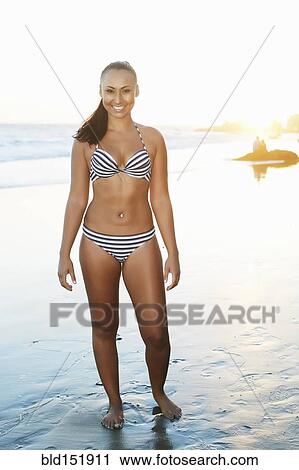 Mixed race woman smiling on beach View Large Photo Image Stock Image - Mixed race woman smiling on beach. Fotosearch
