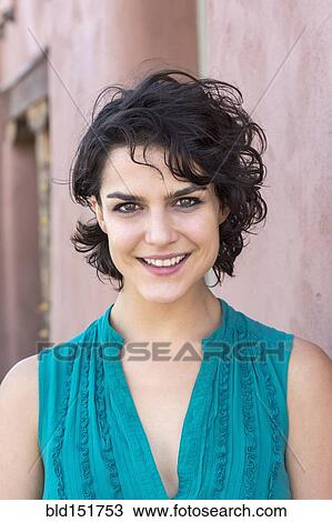 Stock Image - Mixed race woman smiling outdoors. Fotosearch