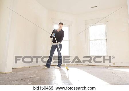 Mixed race woman sweeping floor of new home View Large Photo Image Stock Image - Mixed race woman sweeping floor of new home. Fotosearch