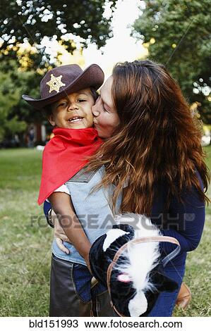 Mother kissing son dressed as cowboy for Halloween View Large Photo Image Stock Image - Mother kissing son dressed as cowboy for Halloween. Fotosearch