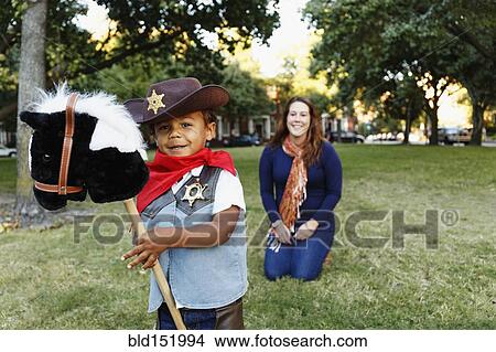 Mother with son dressed as cowboy for Halloween View Large Photo Image Picture - Mother with son dressed as cowboy for Halloween. Fotosearch