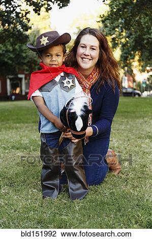 Mother with son dressed as cowboy for Halloween View Large Photo Image Stock Image - Mother with son dressed as cowboy for Halloween. Fotosearch