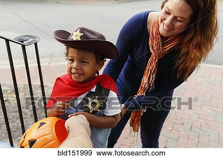 Mother with son trick dressed as cowboy for Halloween View Large Photo Image Stock Photo - Mother with son trick dressed as cowboy for Halloween. Fotosearch