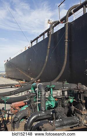 Stock Photo - Oil tanker ship docked in industrial harbor. Fotosearch
