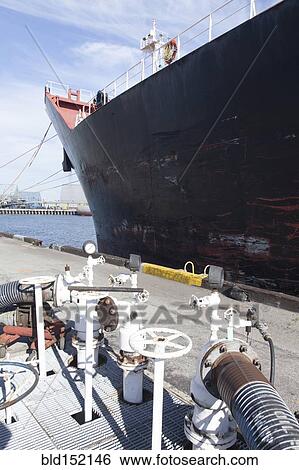 Oil tanker ship docked in industrial harbor View Large Photo Image Stock Photograph - Oil tanker ship docked in industrial harbor. Fotosearch