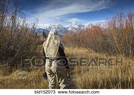 Older Caucasian woman carrying fishing supplies in field View Large Photo Image Stock Image - Older Caucasian woman carrying fishing supplies in field. Fotosearch