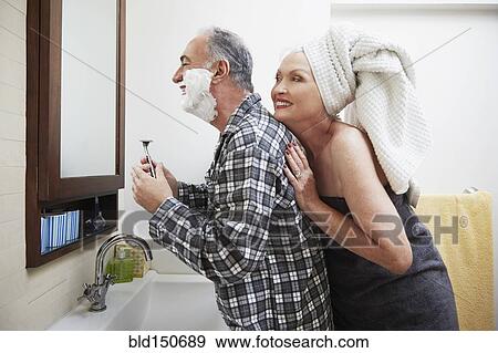 Older couple getting ready in bathroom View Large Photo Image Stock Photo - Older couple getting ready in bathroom. Fotosearch