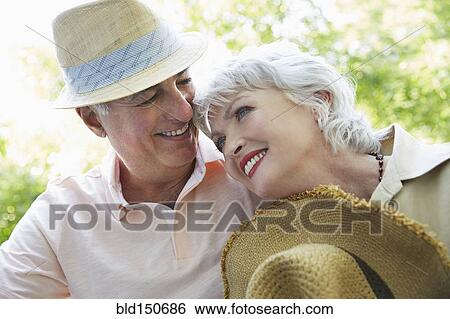 Older couple smiling outdoors View Large Photo Image Stock Photograph - Older couple smiling outdoors. Fotosearch