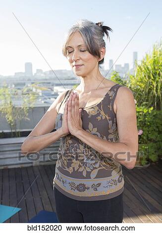 Older mixed race woman practicing yoga on urban rooftop View Large Photo Image Stock Image - Older mixed race woman practicing yoga on urban rooftop. Fotosearch