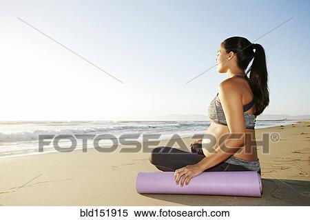 Pregnant Hispanic woman meditating on beach View Large Photo Image Stock Photography - Pregnant Hispanic woman meditating on beach. Fotosearch
