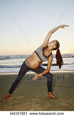 Pregnant Hispanic woman practicing yoga on beach View Large Photo Image Stock Image - Pregnant Hispanic woman practicing yoga on beach. Fotosearch