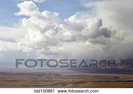 "Puffy clouds rolling over rock formations in desert landscape, Page, Arizona, United States" View Large Photo Image Stock Image - "Puffy clouds rolling over rock formations in desert landscape, Page, Arizona, United States". Fotosearch