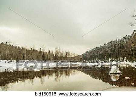 Remote hills reflecting in still lake View Large Photo Image Stock Photo - Remote hills reflecting in still lake. Fotosearch