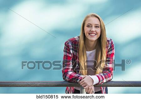 Smiling Caucasian woman leaning on banister View Large Photo Image Stock Photography - Smiling Caucasian woman leaning on banister. Fotosearch