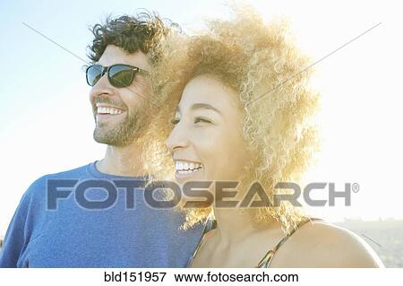 Stock Photo - Smiling couple laughing outdoors. Fotosearch