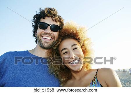 Stock Photo - Smiling couple laughing outdoors. Fotosearch