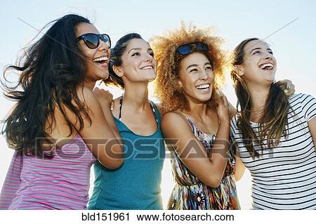 Stock Image - Smiling women posing outdoors. Fotosearch