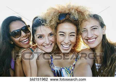 Smiling women taking selfie together outdoors View Large Photo Image Stock Image - Smiling women taking selfie together outdoors. Fotosearch