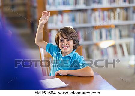 Student raising his hand in library View Large Photo Image Picture - Student raising his hand in library. Fotosearch