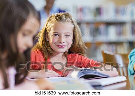 Stock Photo - Student smiling in library. Fotosearch