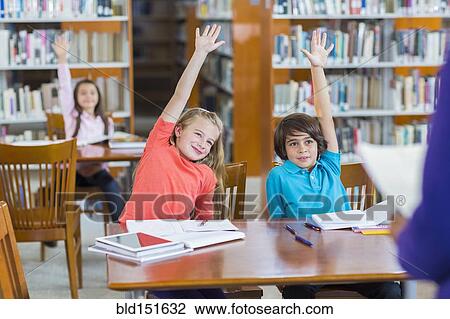 Students raising their hands in library View Large Photo Image Stock Image - Students raising their hands in library. Fotosearch