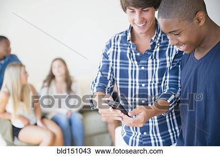 Teenage boys using cell phone View Large Photo Image Stock Image - Teenage boys using cell phone. Fotosearch