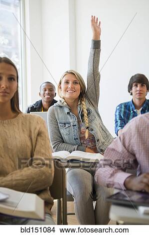 Teenage student raising hand in classroom View Large Photo Image Picture - Teenage student raising hand in classroom. Fotosearch