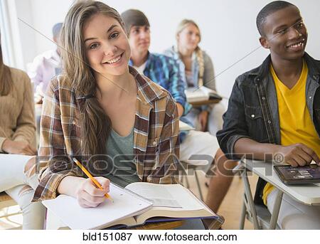 Teenage student smiling in classroom View Large Photo Image Stock Photo - Teenage student smiling in classroom. Fotosearch