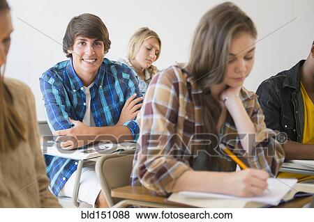 Stock Photo - Teenage student smiling in classroom. Fotosearch