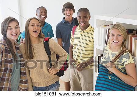 Stock Image - Teenage students smiling at school. Fotosearch