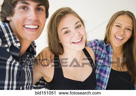 Stock Image - Teenagers hugging and smiling. Fotosearch